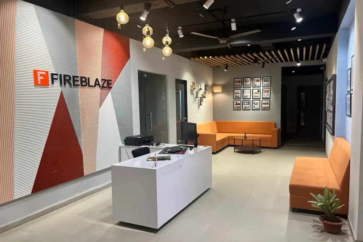 The reception area at Fireblaze's Nandanvan centre in Nagpur, with the Fireblaze mark on the wall behind the desk.